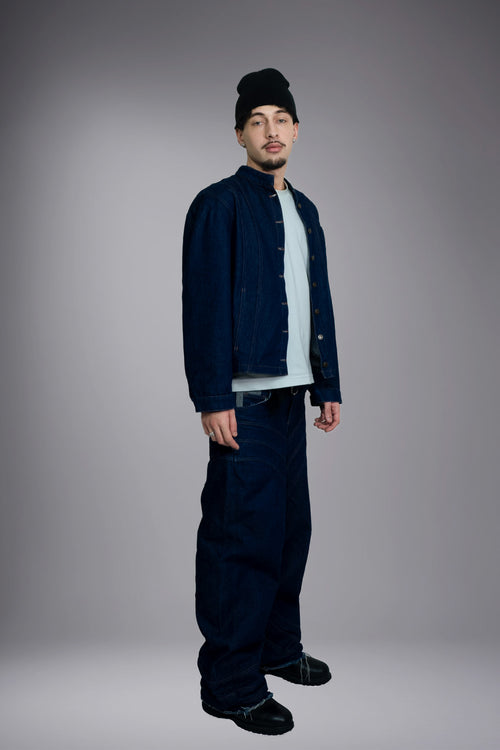 Full-body front view of a dark raw denim jacket worn open with matching wide baggy jeans. - Motor Cycle Brut