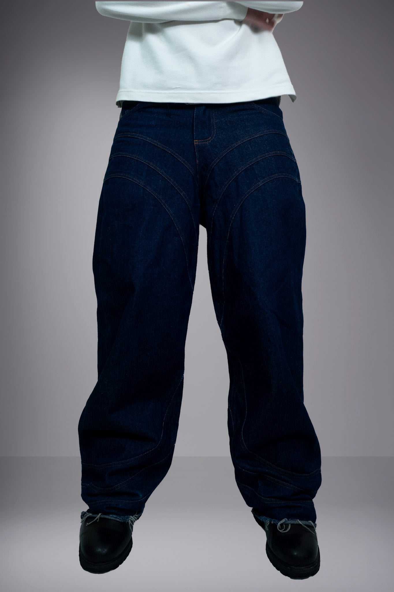Front view of dark raw denim baggy jeans with curved stitching and a wide-leg fit - Motor Cycle Brut