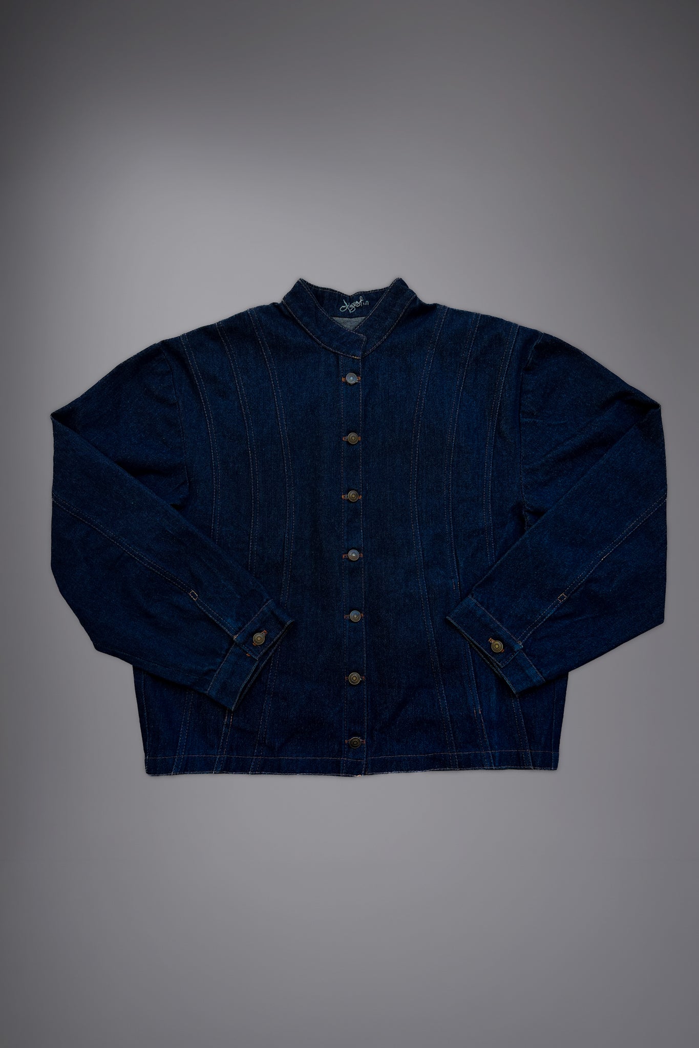 lat lay of a dark raw denim jacket with metal button closure, structured collar, contrast stitching and wide sleeves. - Motor Cycle Brut