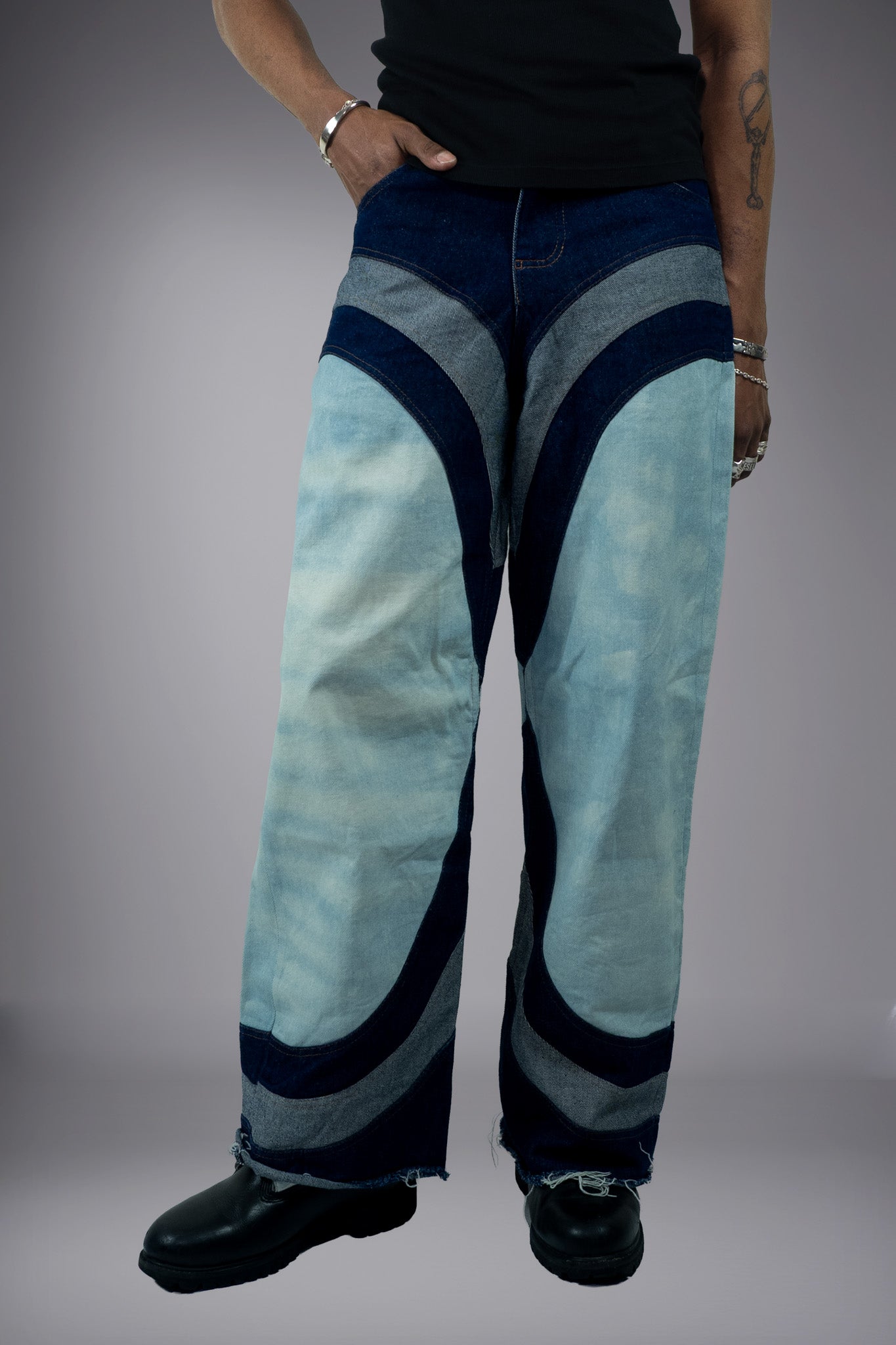 Front view of two-tone wide-leg denim jeans with light wash panels, dark curved inserts and raw hem details. - Motor Cycle Triple Jean