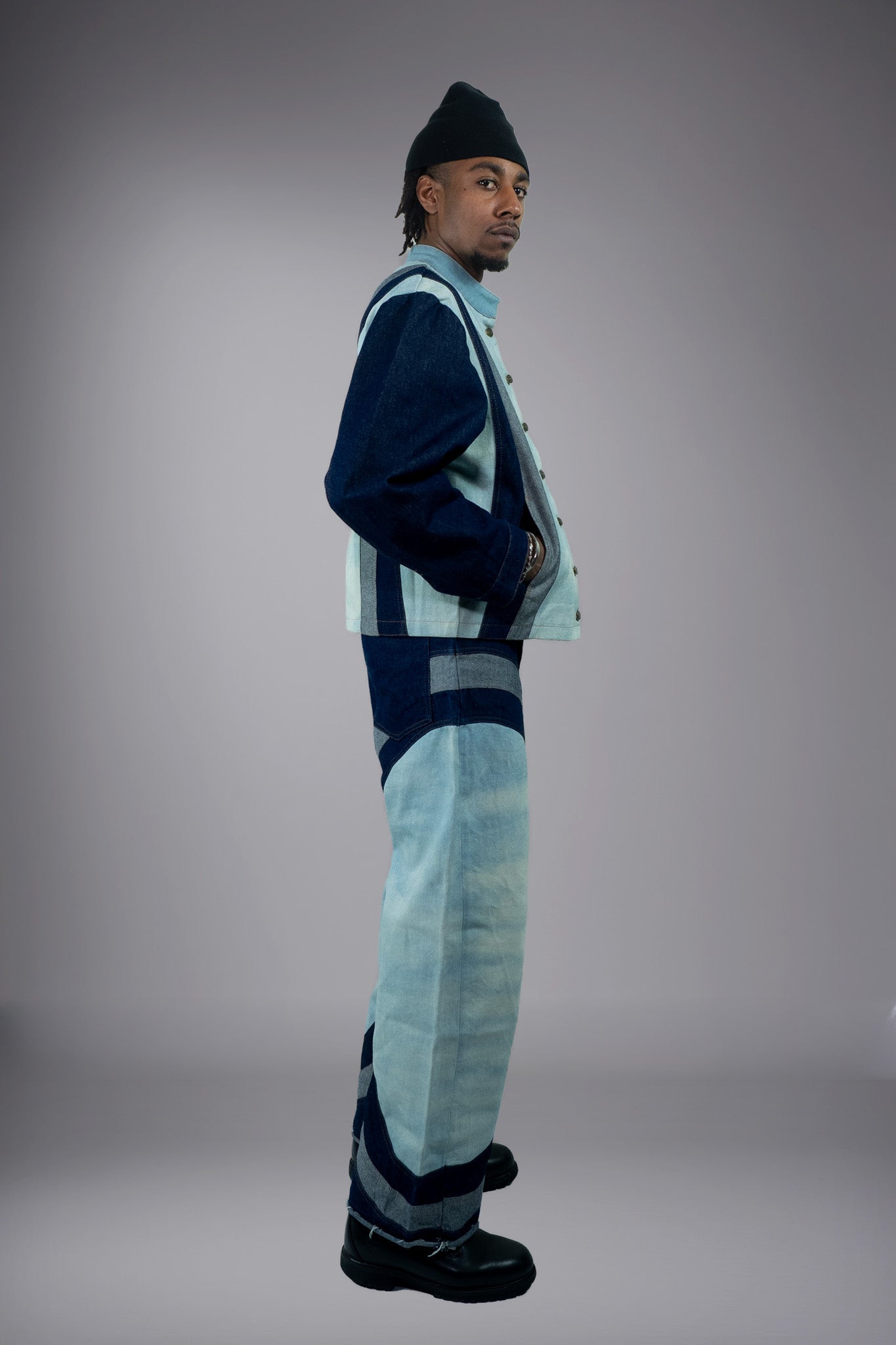 Side view of a two-tone denim jacket and matching wide-leg jeans with light wash panels and dark curved inserts. - Motor Cycle Triple Jean