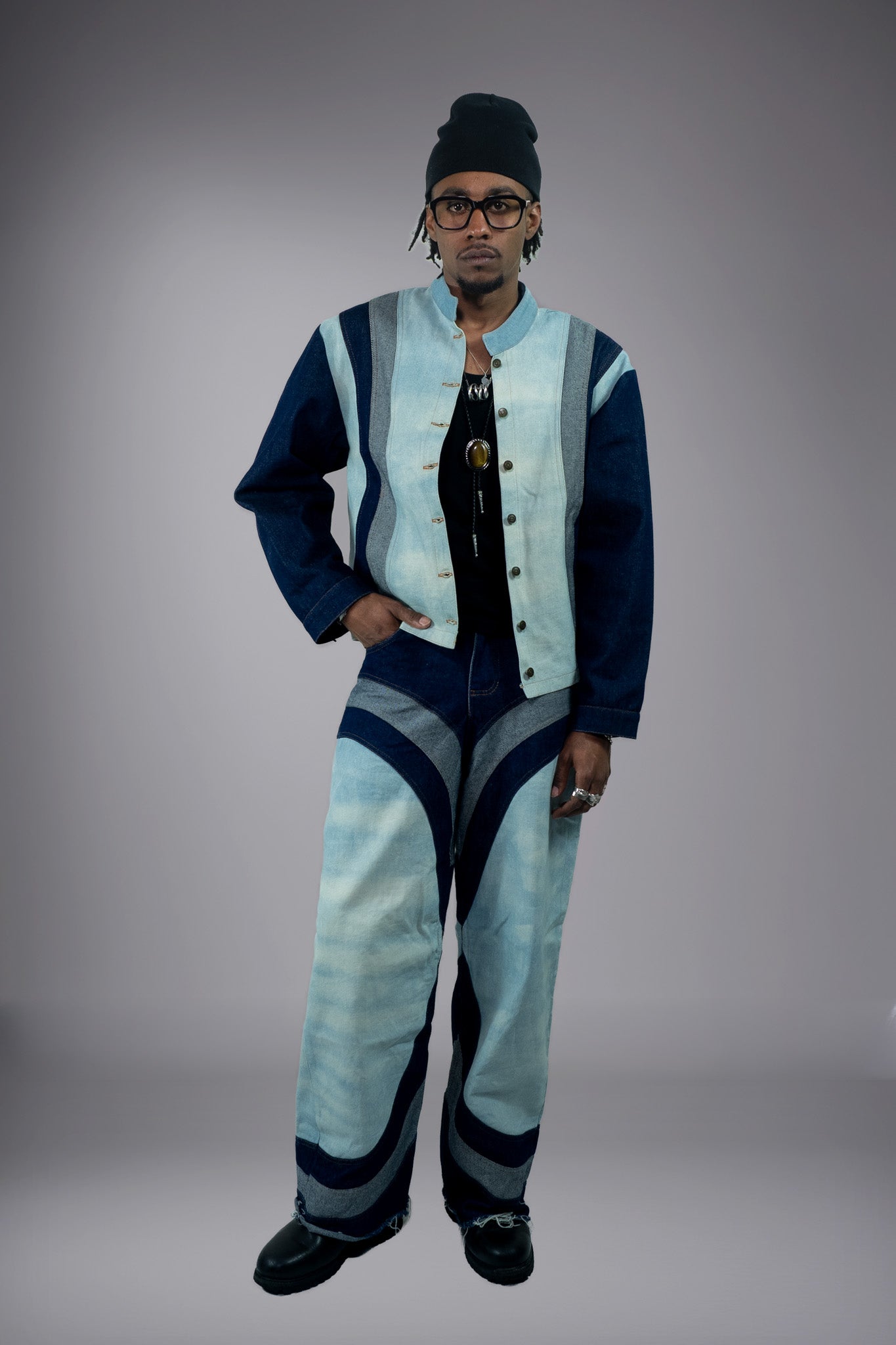 Full-body front view of a two-tone denim jacket worn open with matching wide-leg jeans and curved panel details. - Motor Cycle Triple Jean