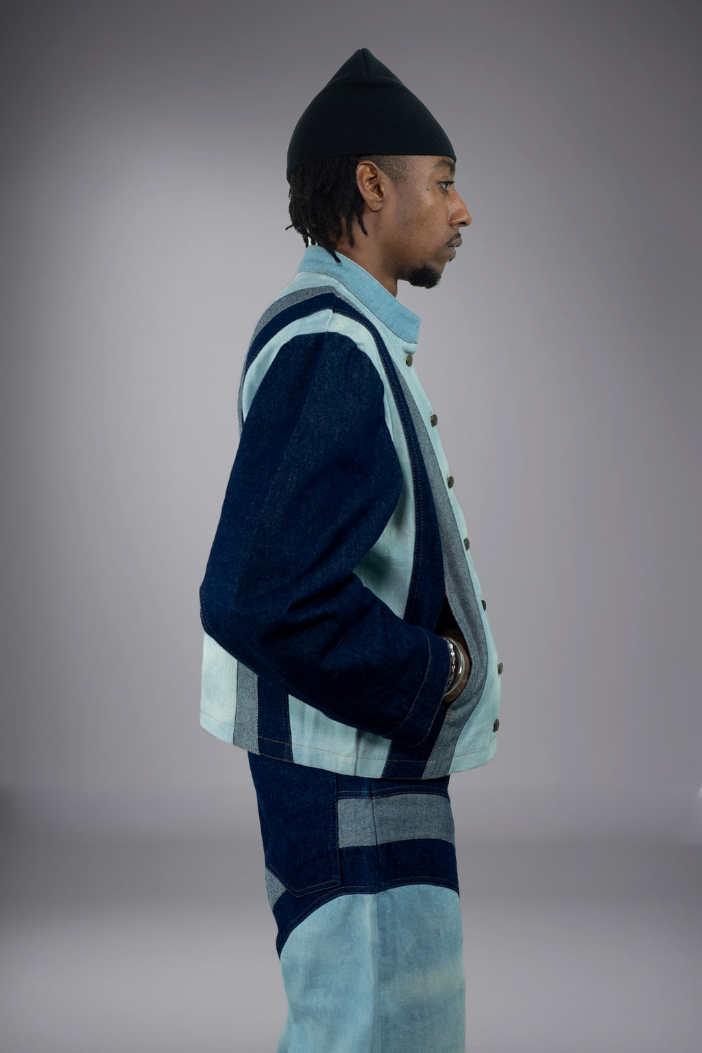 Side view of a two-tone denim jacket with light wash panels, dark denim sleeves, vertical panel construction and contrast stitching. - Motor Cycle Triple Jean