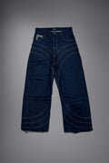 Flat lay of dark raw denim baggy jeans with curved contrast stitching and wide-leg construction - Motor Cycle Brut